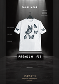 A white short-sleeve t-shirt with a black butterfly graphic print on the front, hanging on a black hanger against a dark, dramatic studio backdrop. The brand name 'FALAH WEAR' is displayed at the top, and the t-shirt is presented on a black pedestal labeled 'PREMIUM FIT'.