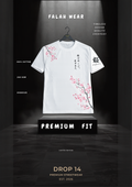 A white short-sleeve T-shirt displayed on a hanger against a dark dramatic backdrop. The shirt has pink cherry blossom branch illustrations and black Japanese-style text on the chest and sleeve.